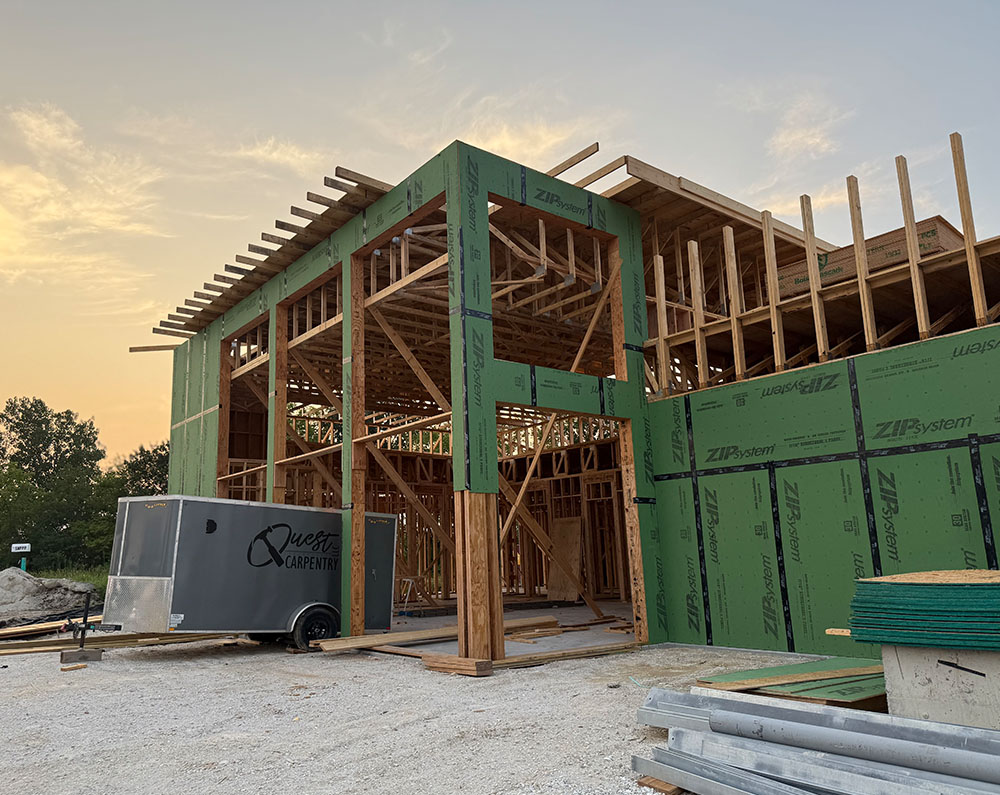 House framing construction underway. House framing construction underway.